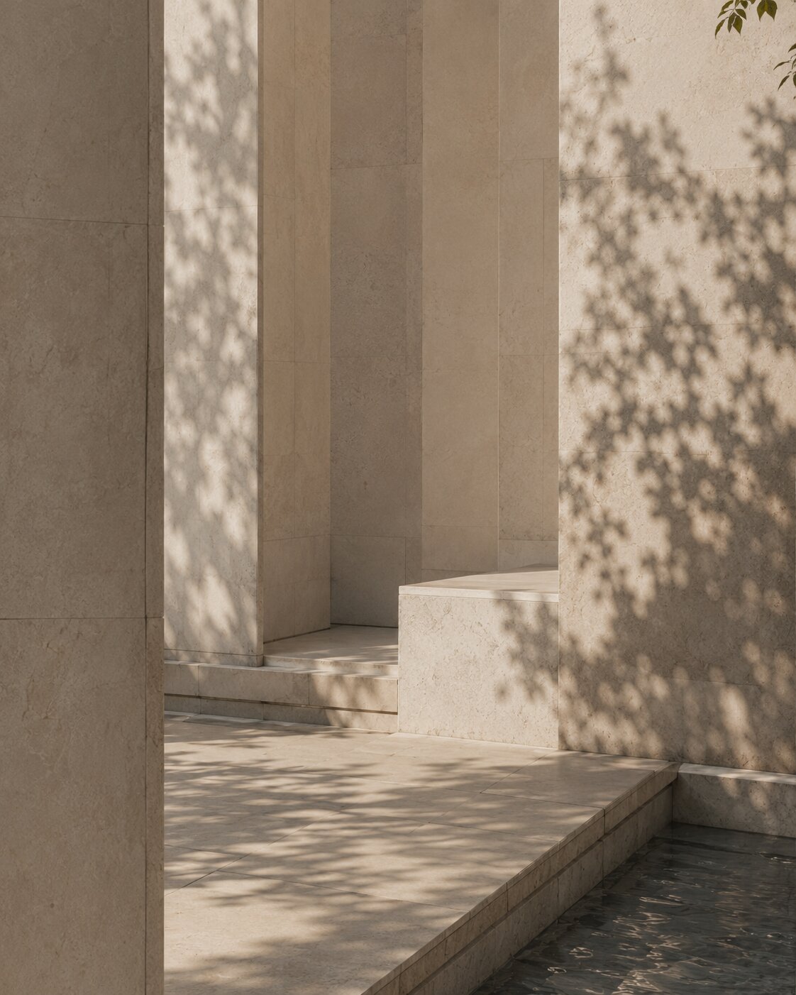 Limestone architectural detail with soft tree shadows